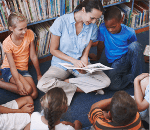 Adult in Library Reading Book to Children